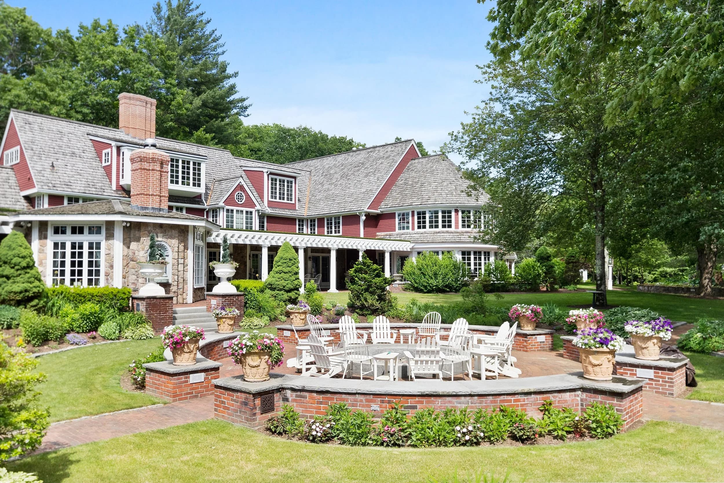 The main house at Juggler Meadow with gardens and the brick firepit circle