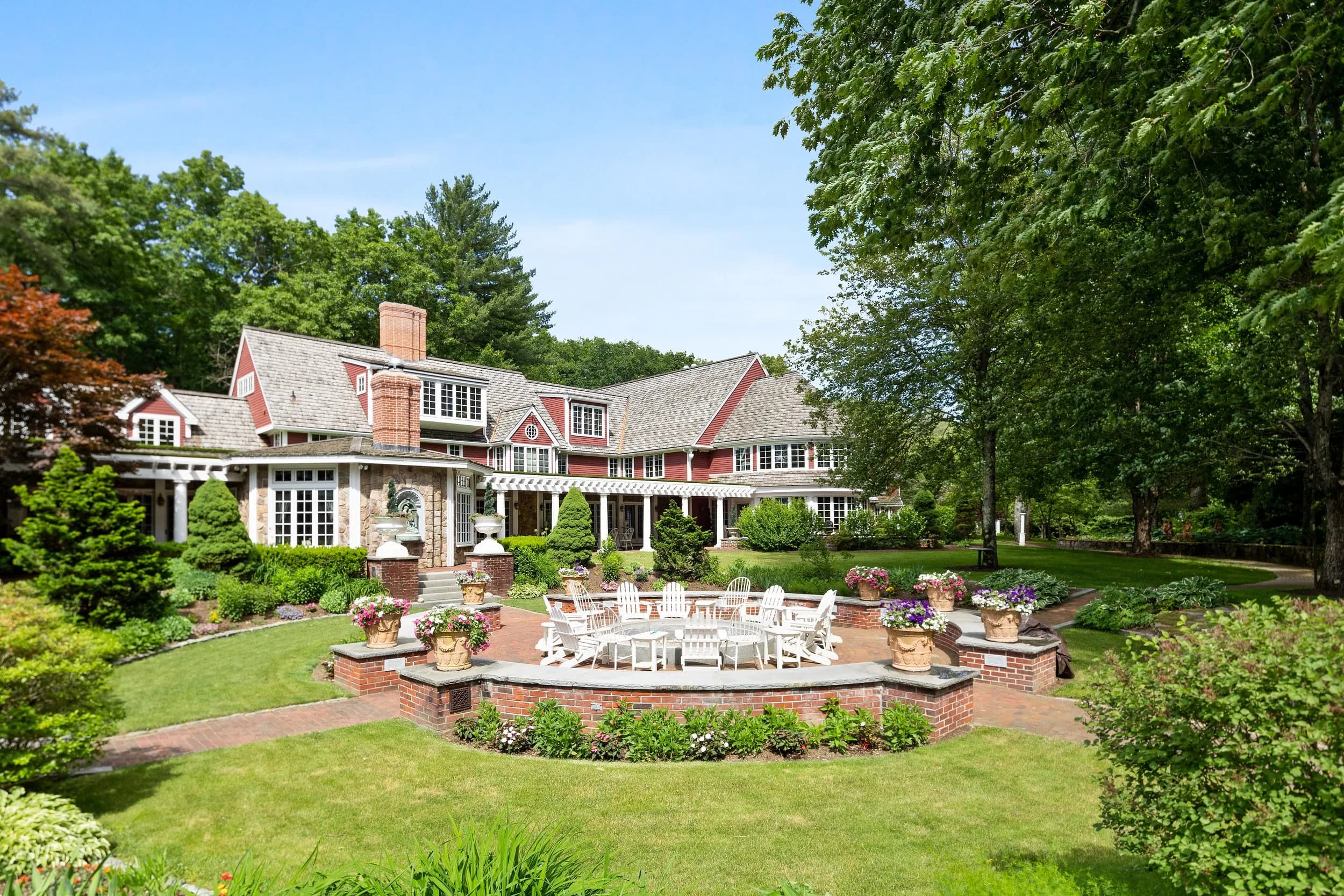 The Main House at Juggler Meadow seen from its gardens and firepit circle