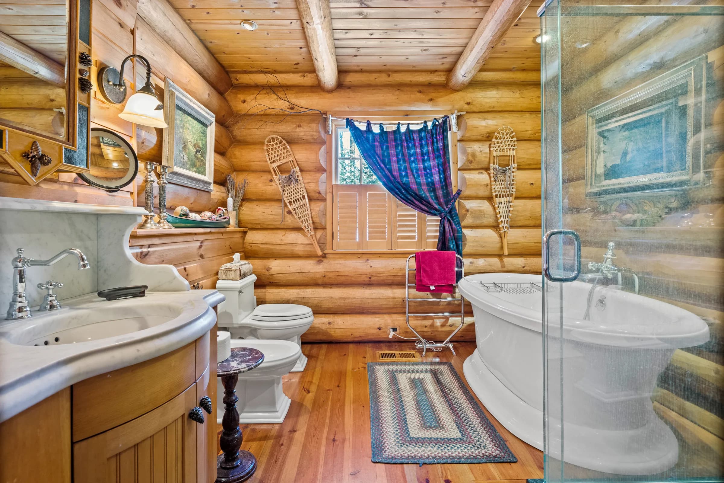 A log-walled Lodge bath with a freestanding tub