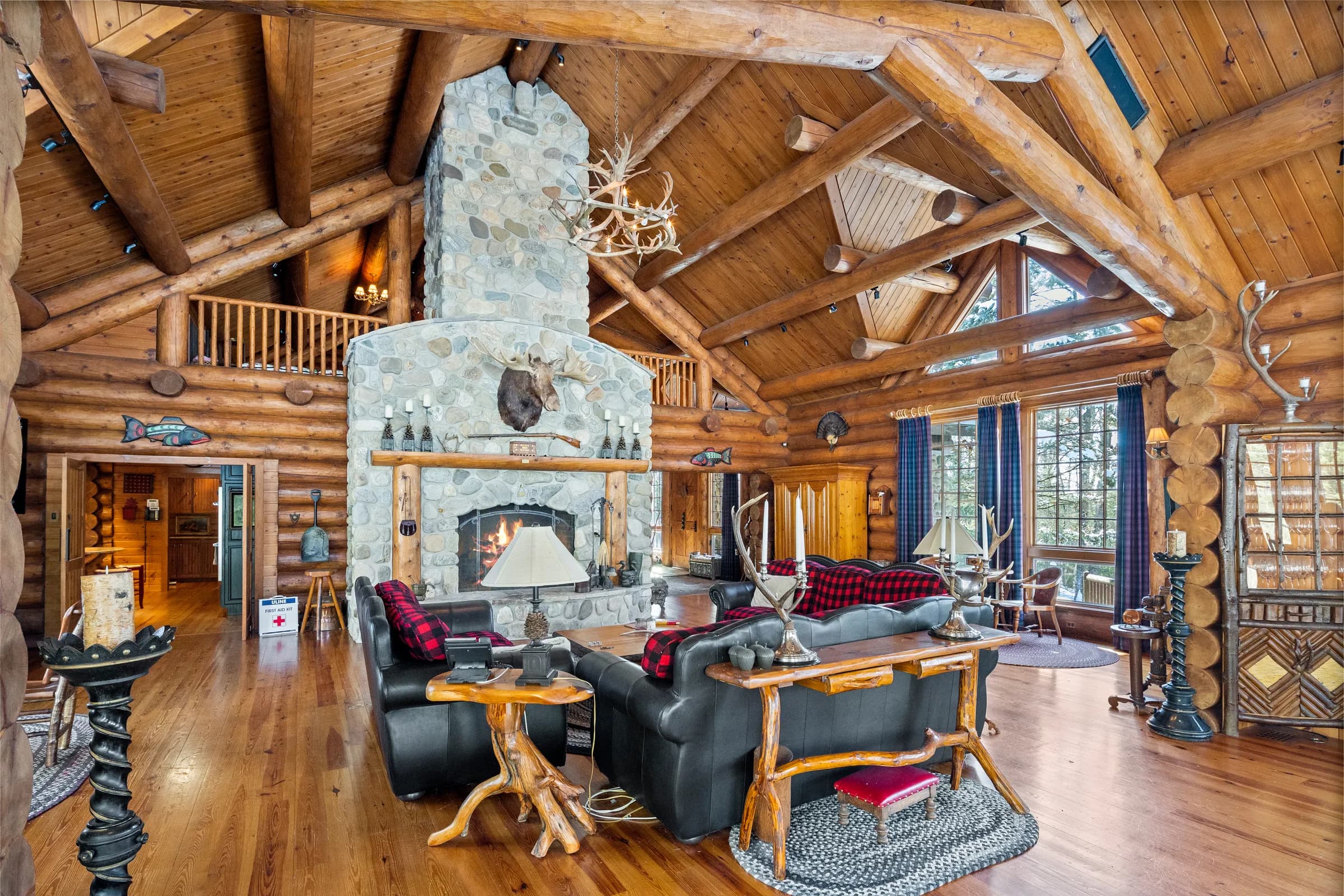 The vaulted great room of The Lodge and its two-story stone fireplace