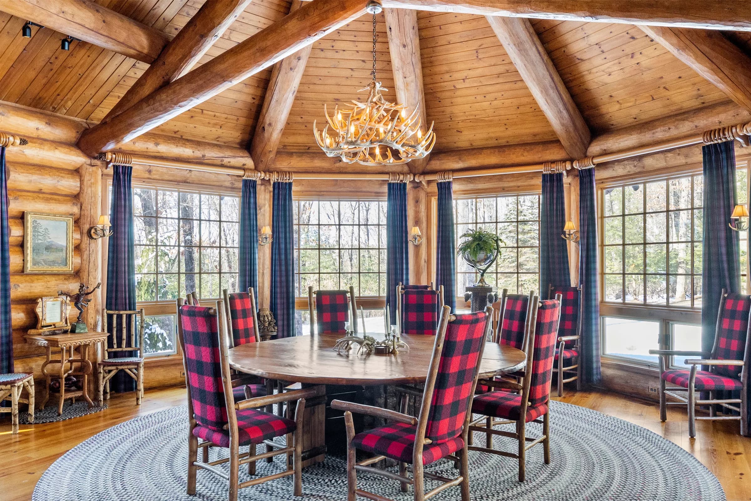 The rotunda dining table set beneath its antler chandelier