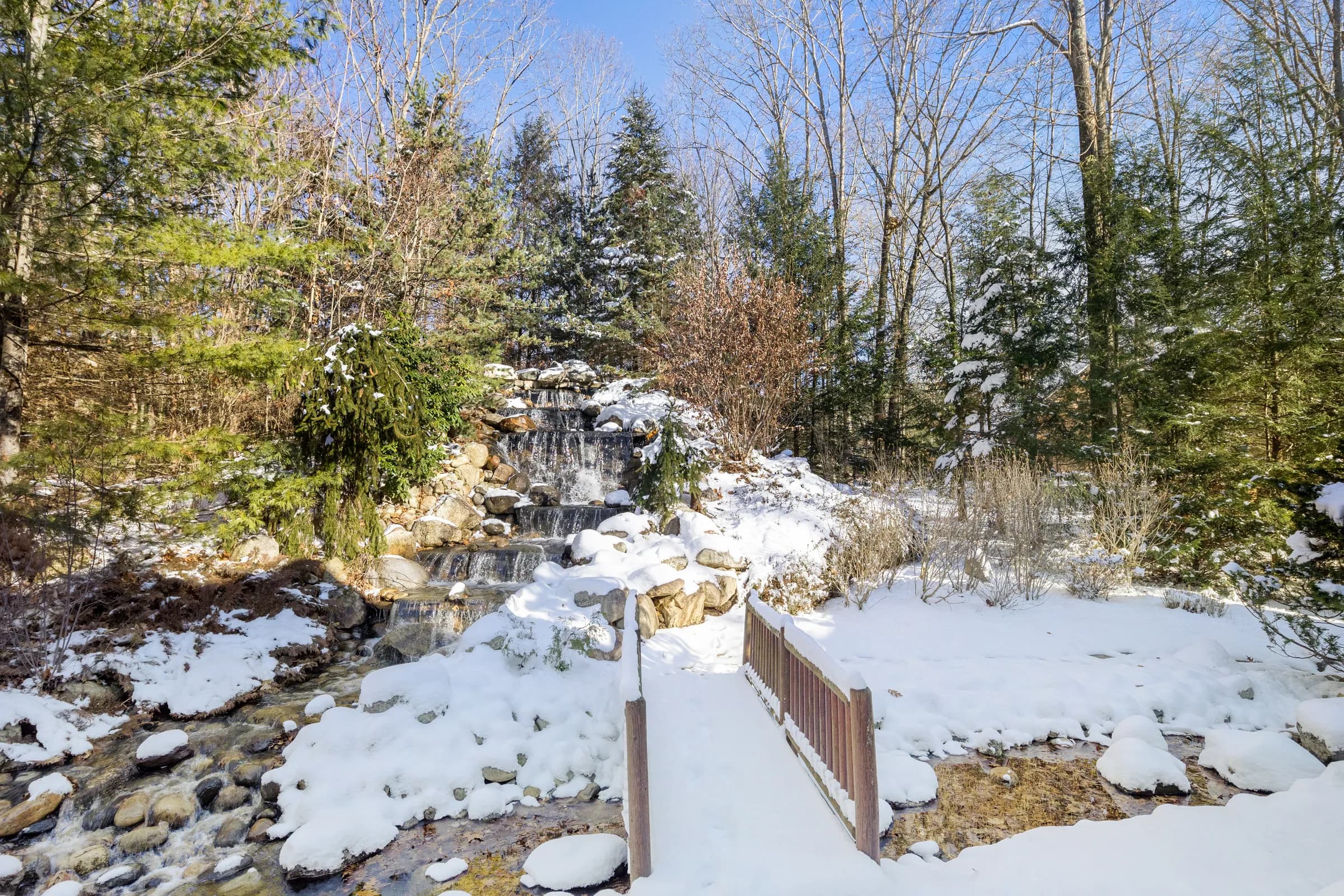 The Lodge's waterfall spilling through snow-covered boulders