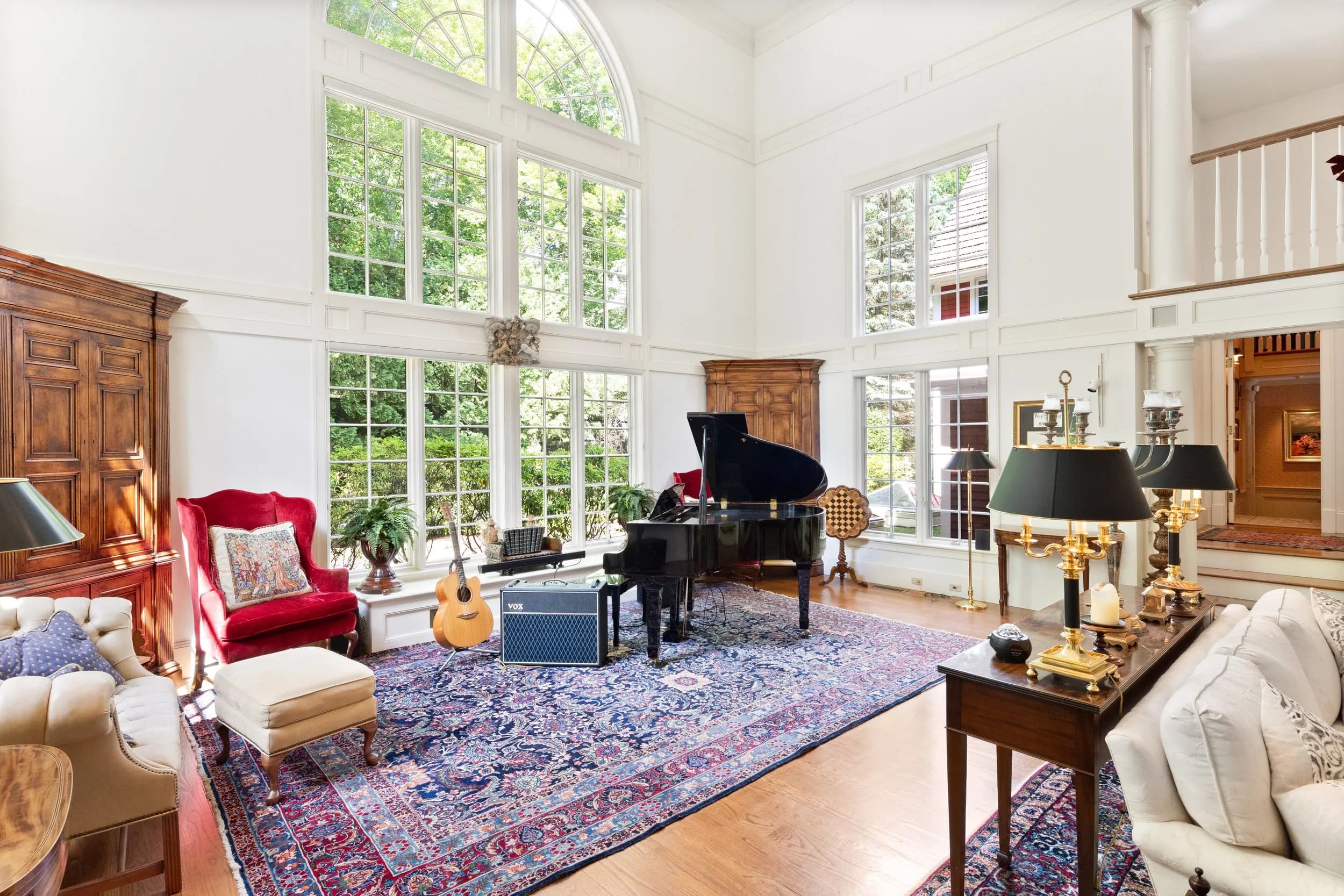 The grand piano beneath the great room's arched window wall