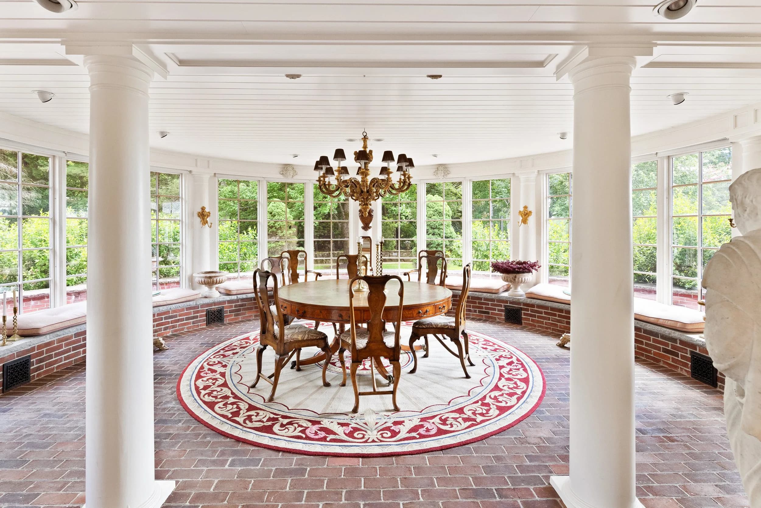 The circular sunroom set for dinner