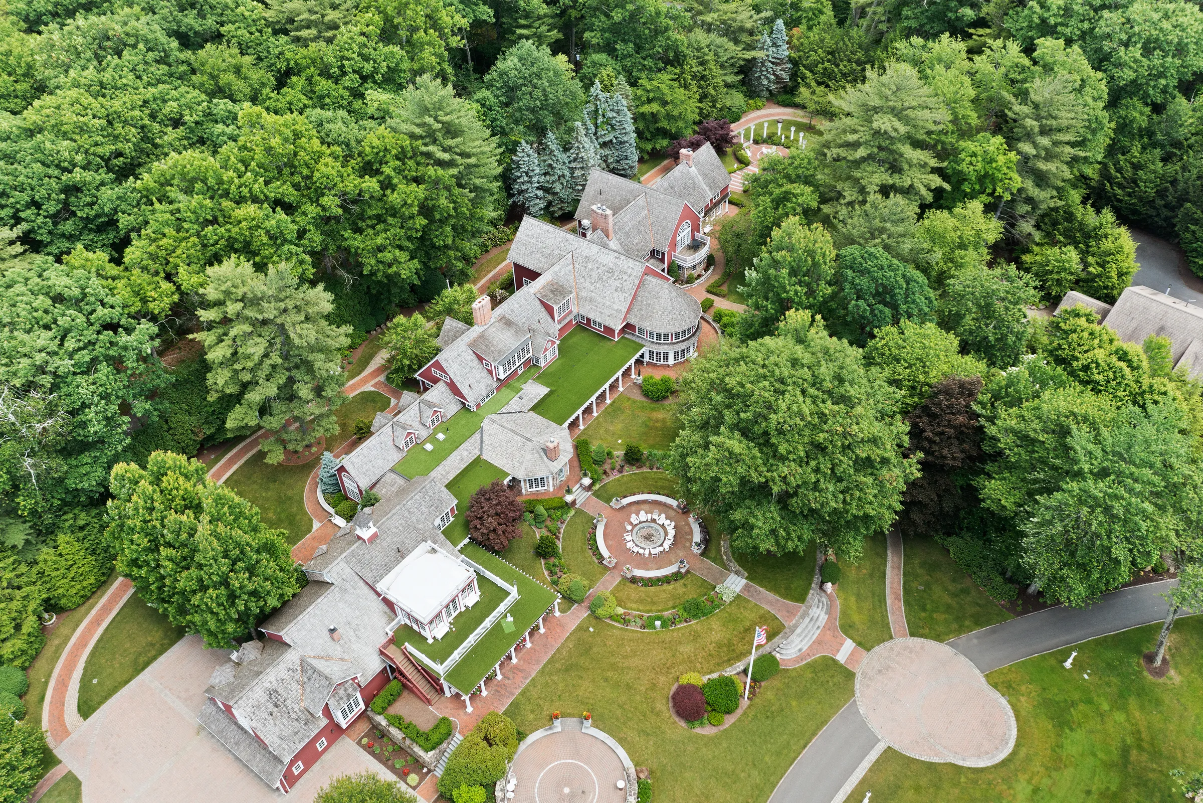 Aerial view of the red-roofed Juggler Meadow estate and its fountain courtyard in Leverett, Massachusetts
