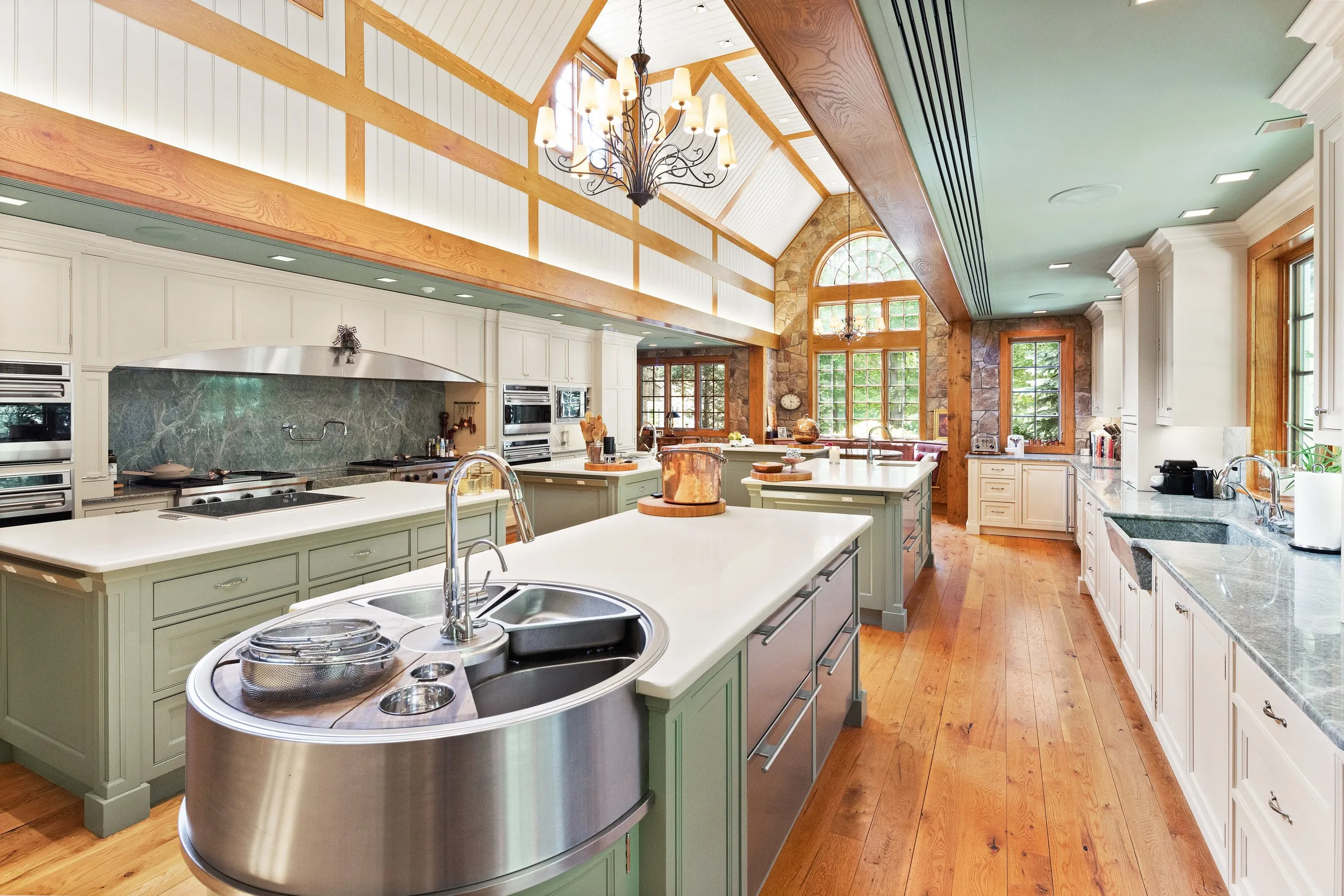 The Main House kitchen beneath its cathedral ceiling and arched stone window